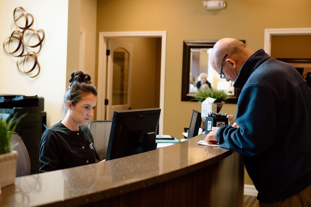 patient checking in at front desk